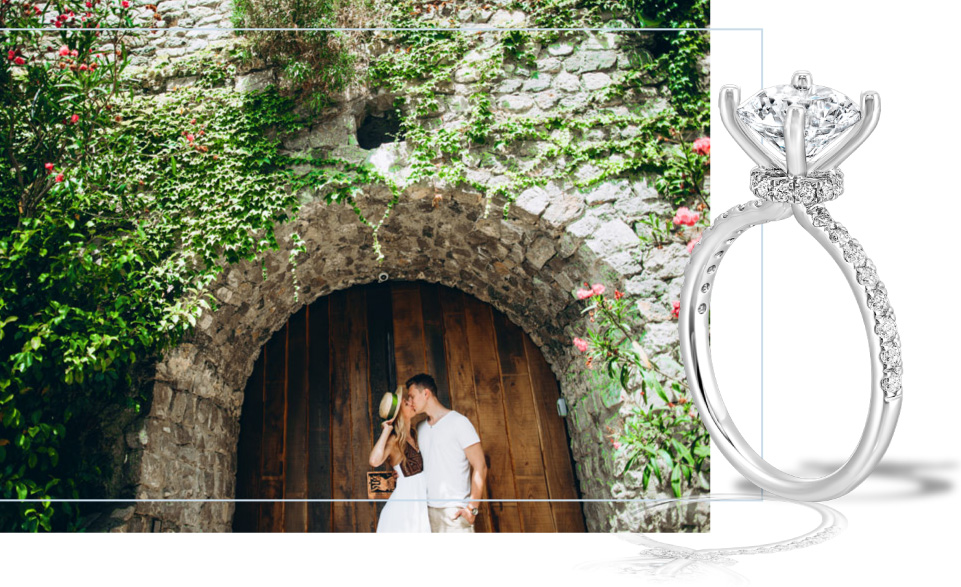 couple in front of door kissing, closeup of diamond ring